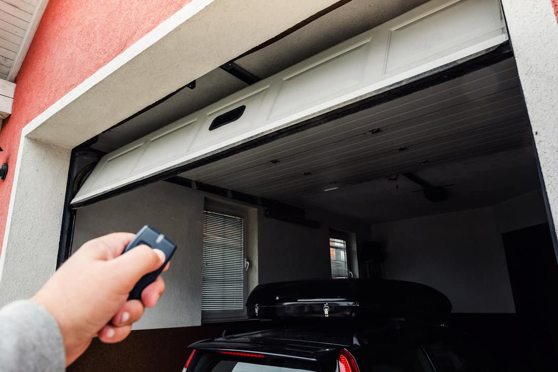 Garage door PVC. Hand use remote controller for closing and opening garage door