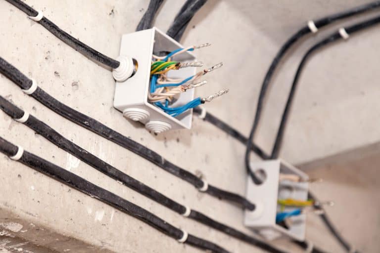 Cable laying ceiling. Electrical wires on wall. Wiring replacement. Connecting light in flat or office. Professional installation bulb, electrical outlet, cables, wires, switches. Insulation