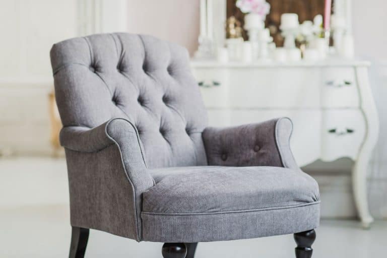 beige color upholstered chair in living room with flowers, Power Washing Upholstered Chairs: What You Should Know Before You Start