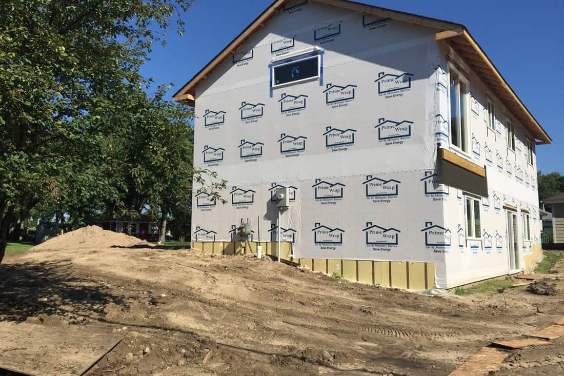 newly constructed home is wrapped in Tyvek to protect the house while under construction