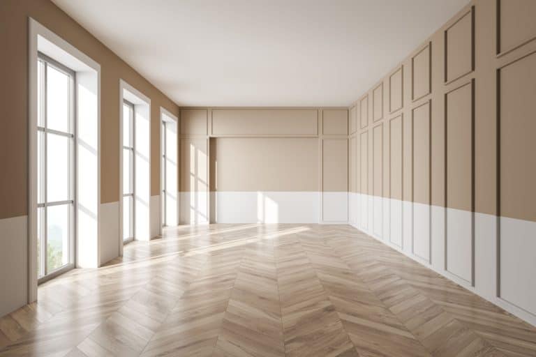 beige and white walls, floor to ceiling windows and parquet flooring