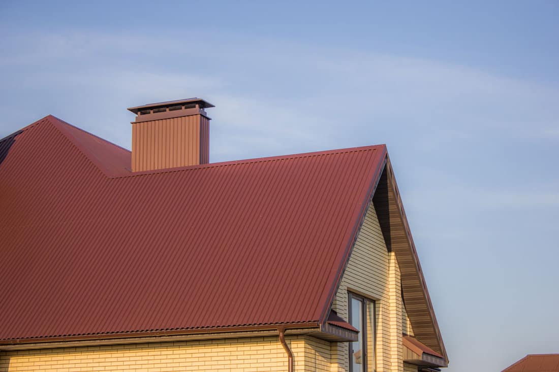 Red metal roofing with beige walls