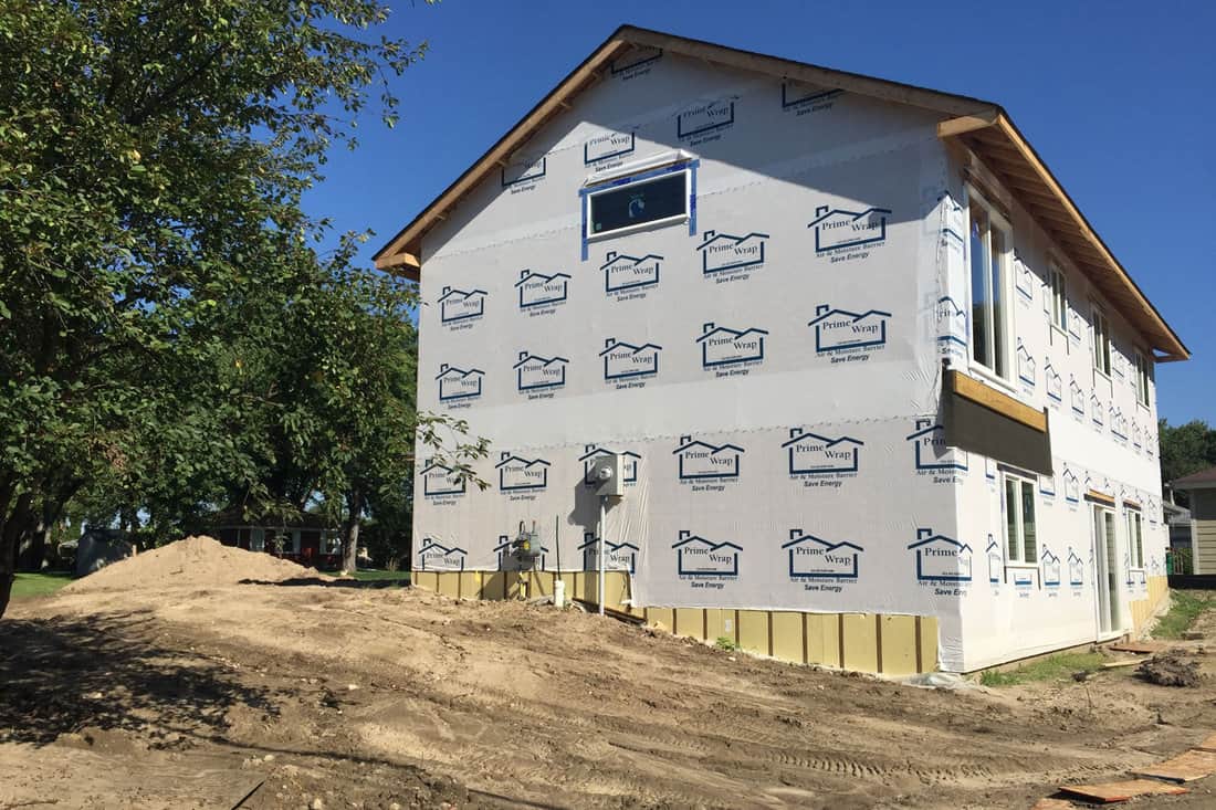 A newly constructed home is wrapped in Tyvek to protect the house while under construction.