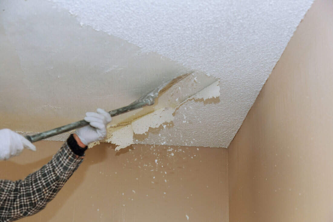 Ceiling drywall demolition: A photo showing the removal of the textured popcorn ceiling to reveal the underlying drywall.