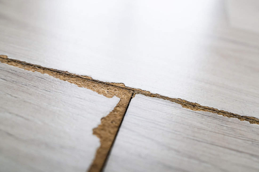Damaged Old Laminate Flooring Surface At Home
