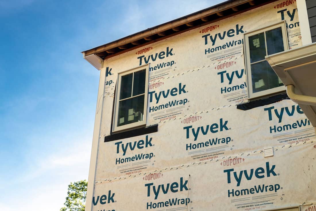 Tyvek house wrap adorns the outer surface of a residential property.