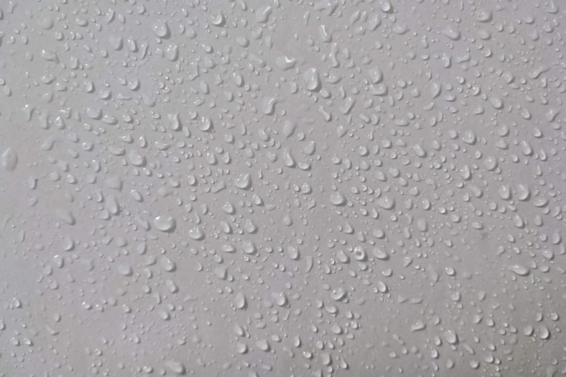 Water drops on the ceramic surface texture.
