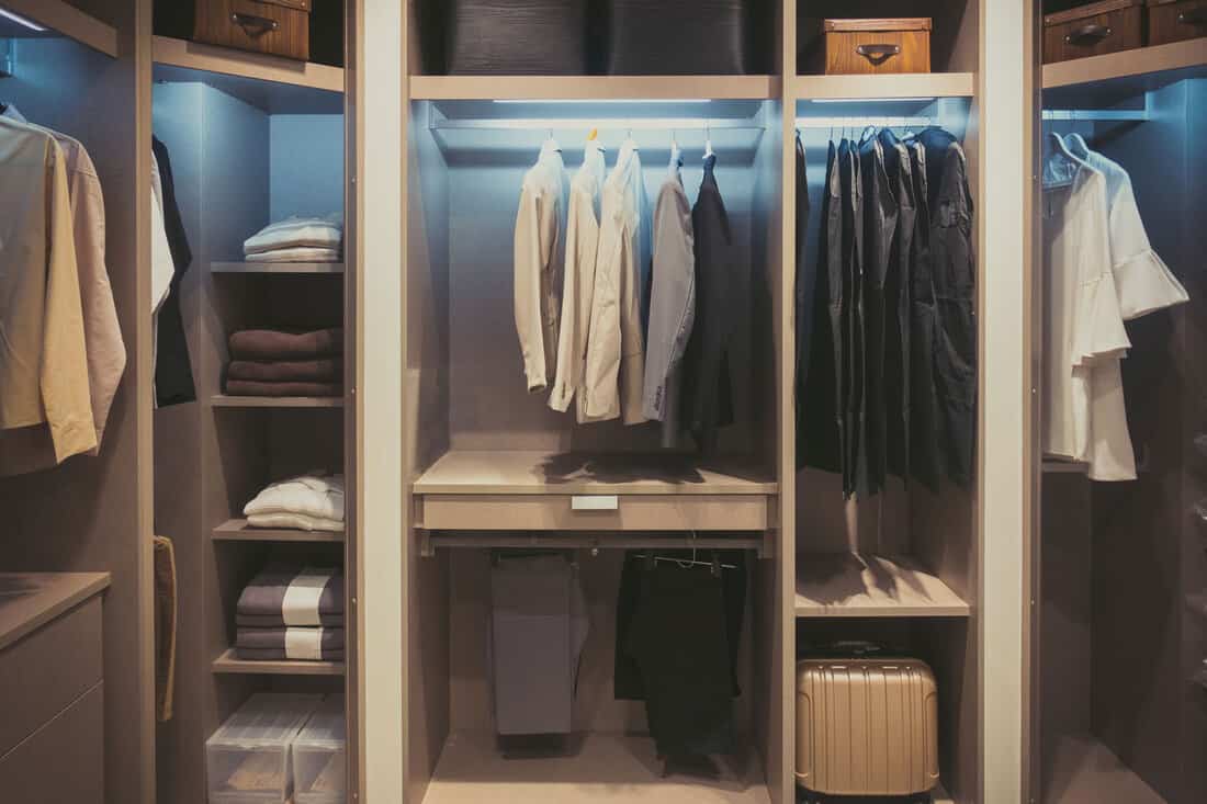 A walk-in closet filled with business cloths