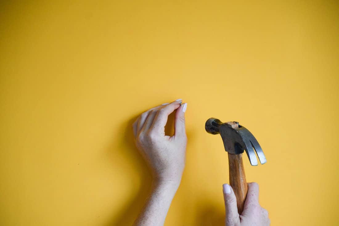 Using a hammer on the wall