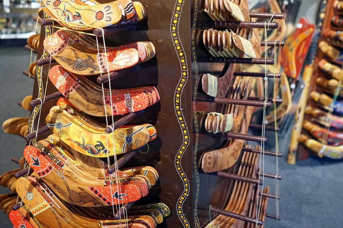 Dozens of wooden boomerangs hanged at a store