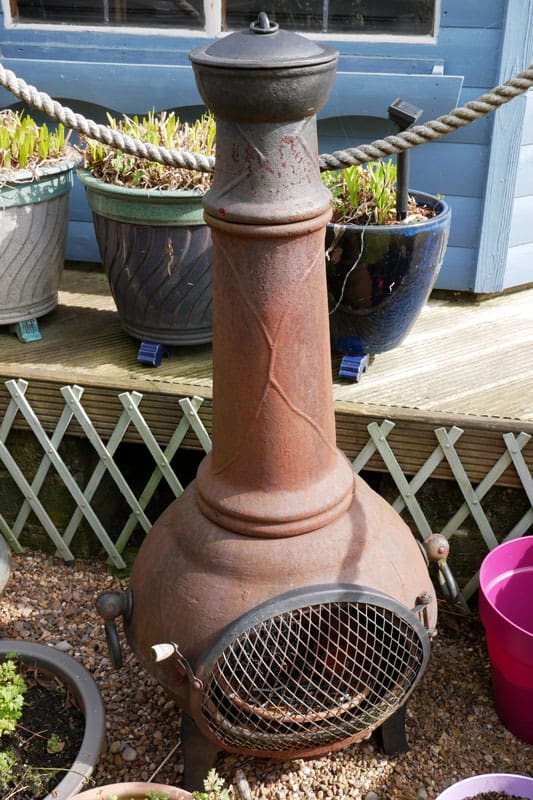 A standard size Chiminea placed outside the garden