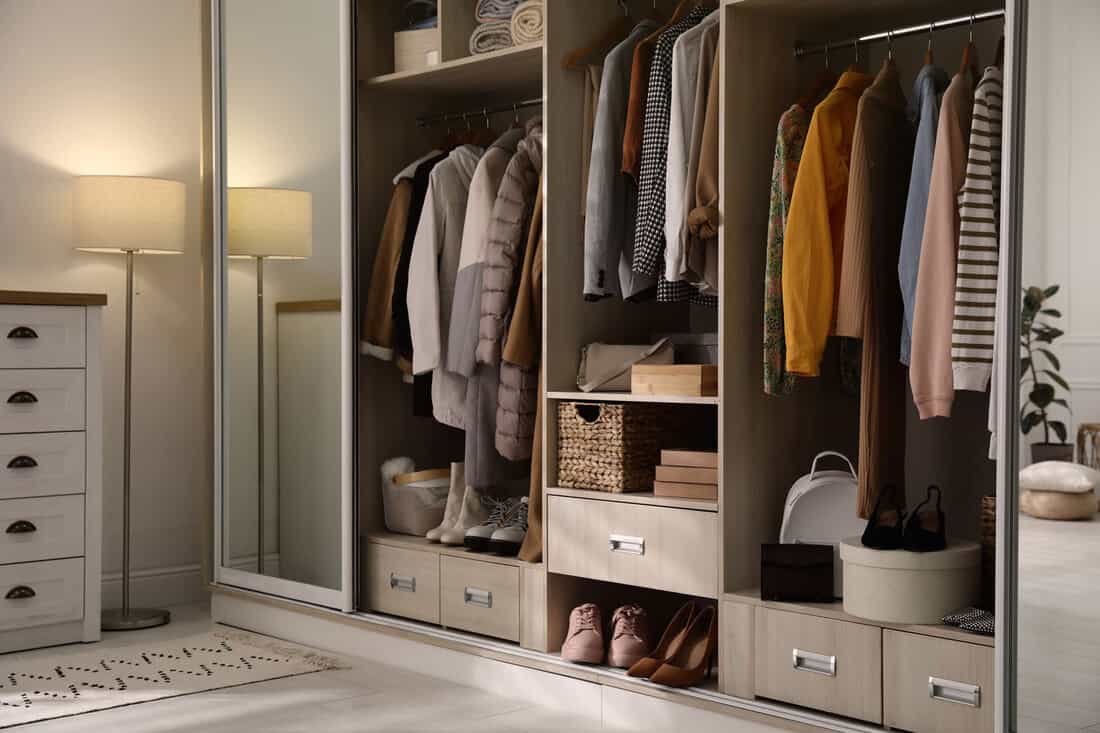 Interior of a modern closet filled with hanged clothes