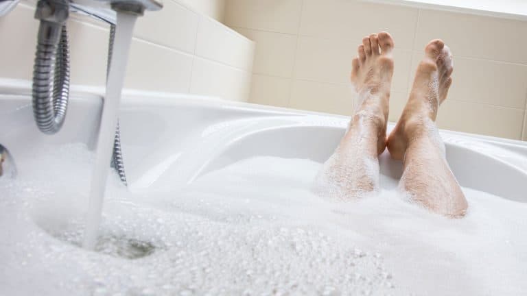 Woman resting her legs, How Far Apart Should Bath Legs Be? - 1600x900