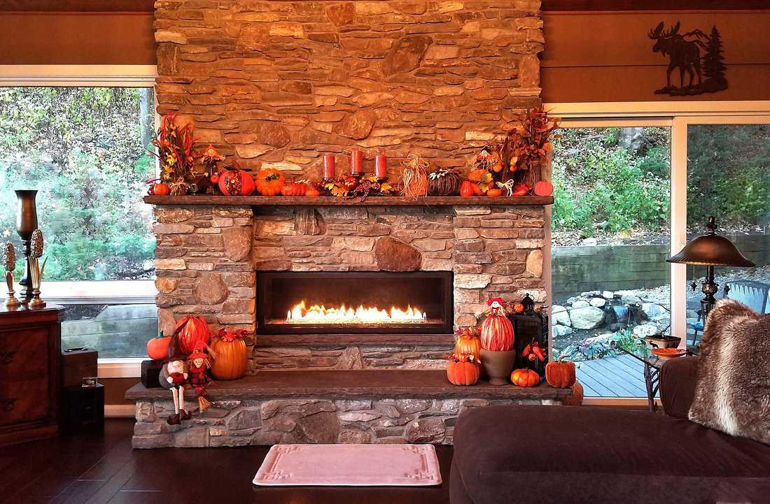 autumnal décor embellishing a rustic stone fireplace
