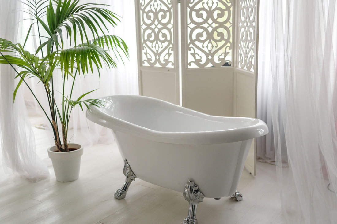 A white bathtub inside a modern bathroom