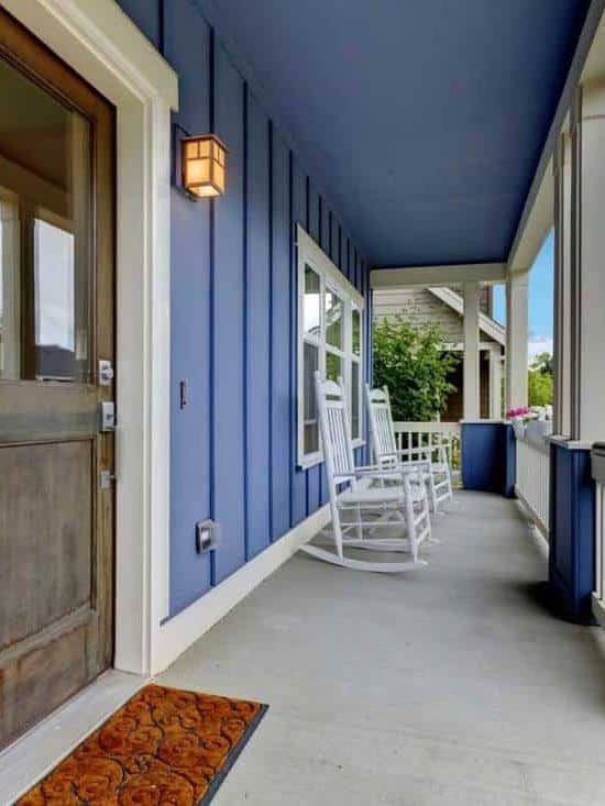 Blue walled front porch with gray colored front door