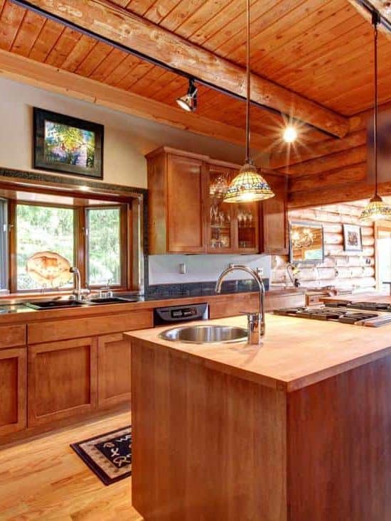 Large kitchen with island in a log cabin