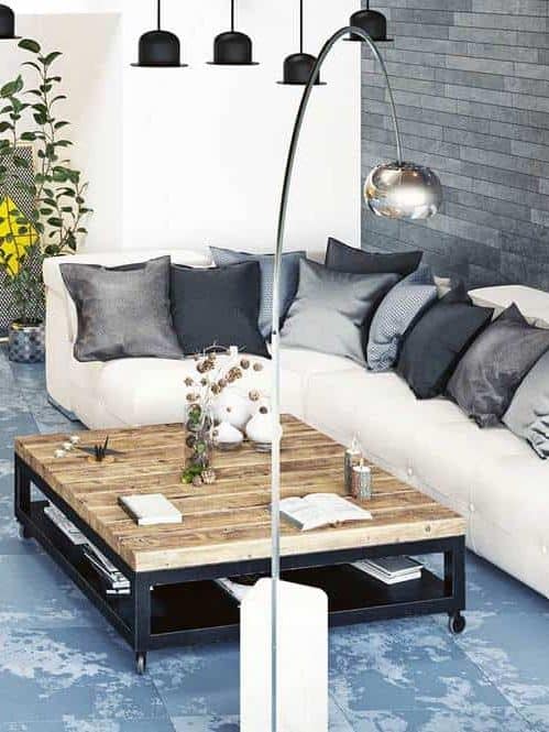 Modern loft living room interior with white corner sofa and dark brick walls