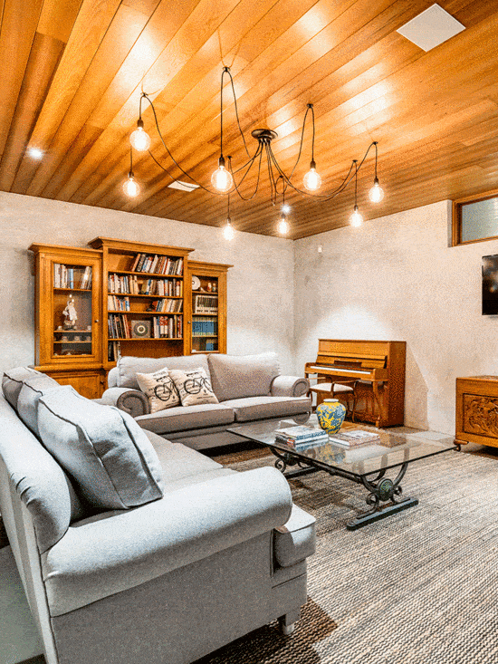Modern rustic basement living room with wooden ceiling