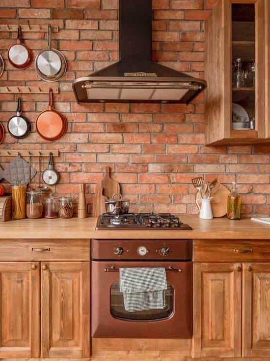 Primitive style kitchen adorned with copper appliances and cooking items