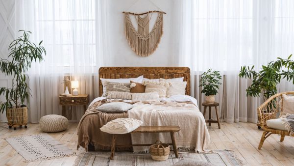 boho bedroom in earth tones with hanging macrame wall decor