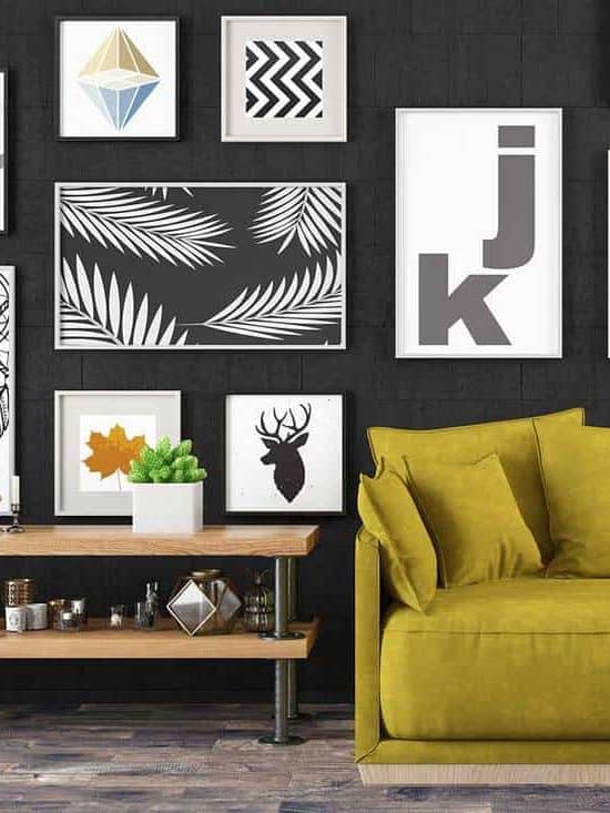 Living room interior with cozy yellow sofa, coffee table, parquet floor and graphic art decors on black wall