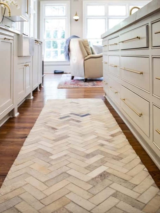 Low view of new renovated kitchen cabinets with Herringbone Runner Rug 